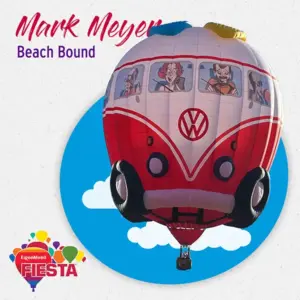 A colorful hot air balloon shaped like a Volkswagen van floats against a blue sky backdrop, featuring cartoonish characters riding inside.