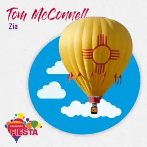A bright yellow hot air balloon with a red emblem floats in front of a blue sky. Fiesta logo present.
