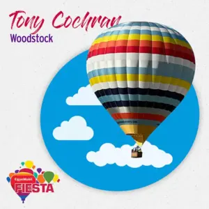 Colorful hot air balloon with stripes ascends in a blue sky with clouds.