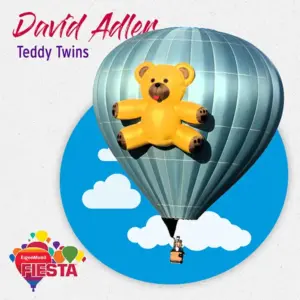 A hot air balloon with a large teddy bear design, carrying a person, against a blue sky with clouds and Fiesta logo.