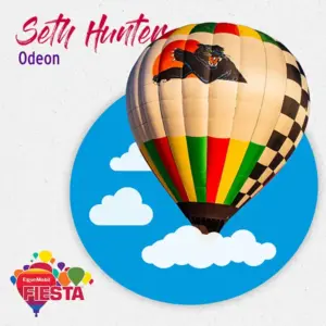 Colorful hot air balloon with a panther design against a blue sky with clouds.