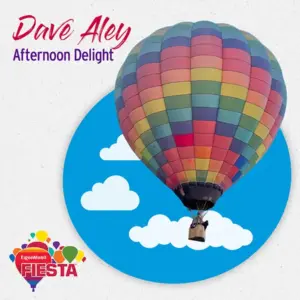 A vibrant hot air balloon against a blue sky with clouds, featuring the text “Dave Aley Afternoon Delight” and “ExxonMobil Fiesta.”