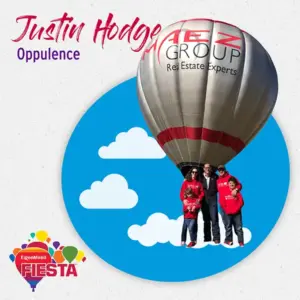 A hot air balloon with four people in red shirts floats among clouds.