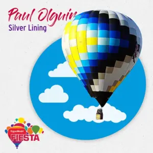 A vibrant hot air balloon with blue, yellow, and black checkered pattern floats against a backdrop of clouds. Text references ExxonMobil Fiesta.