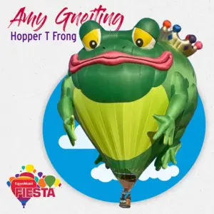A colorful frog-shaped hot air balloon with a crown floats in the sky.