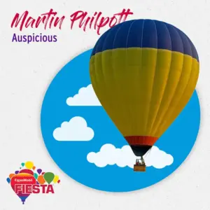 A yellow and blue hot air balloon floats against a blue sky with clouds, ExxonMobil Fiesta branding in corner.