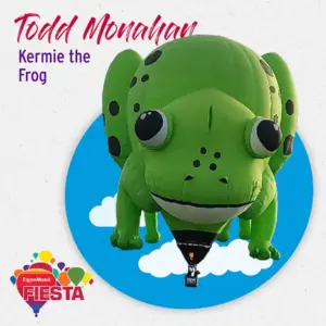 A large green frog-shaped hot air balloon named