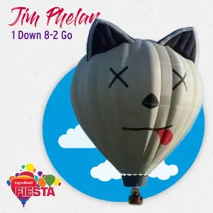 A hot air balloon shaped like a cartoon cat against a sky background, promoting the ExxonMobil Fiesta event with colorful logos and text.