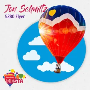 A colorful hot air balloon rises against a blue sky with clouds.