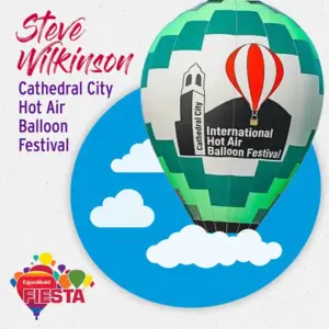 A hot air balloon at Cathedral City International Hot Air Balloon Festival with a colorful graphic background and festival sponsor logo.