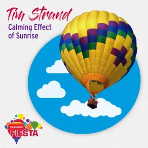 Balloon festival advertisement featuring a vibrant hot air balloon against a blue sky with clouds. Text highlights artist and event name.