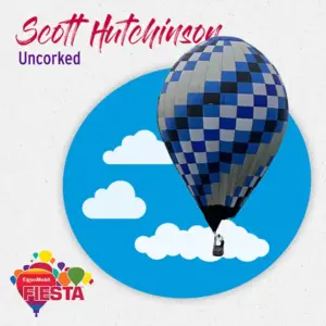 A checkered hot air balloon floats against a cloudy blue sky backdrop, promoting the ExxonMobil Fiesta event titled