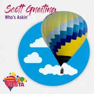 A colorful hot air balloon with a person inside is centered in a circular sky design.