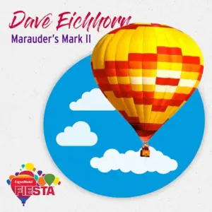 A colorful hot air balloon floats in a blue sky with white clouds, featuring text and a logo from a balloon festival.