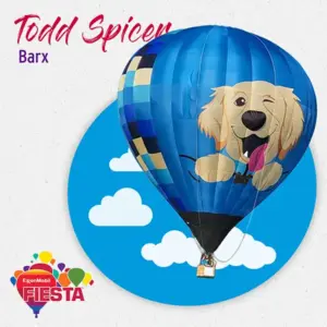 A blue hot air balloon featuring a playful dog design hovers against a cloud backdrop, with Fiesta branding in the corner.
