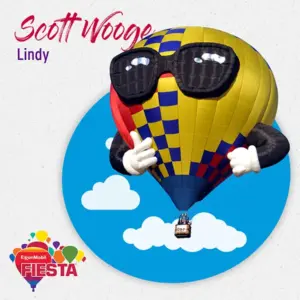 A colorful hot air balloon with glasses and gloves floats against a blue sky and white clouds, promoting ExxonMobil FIESTA.
