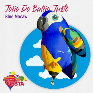 A vibrant blue macaw hot air balloon floats against a sky background at the ExxonMobil Fiesta event, showcasing creative balloon art.