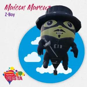 A whimsical hot air balloon shaped like a person in a hat and mask floats against a blue sky with clouds. Event branding visible.