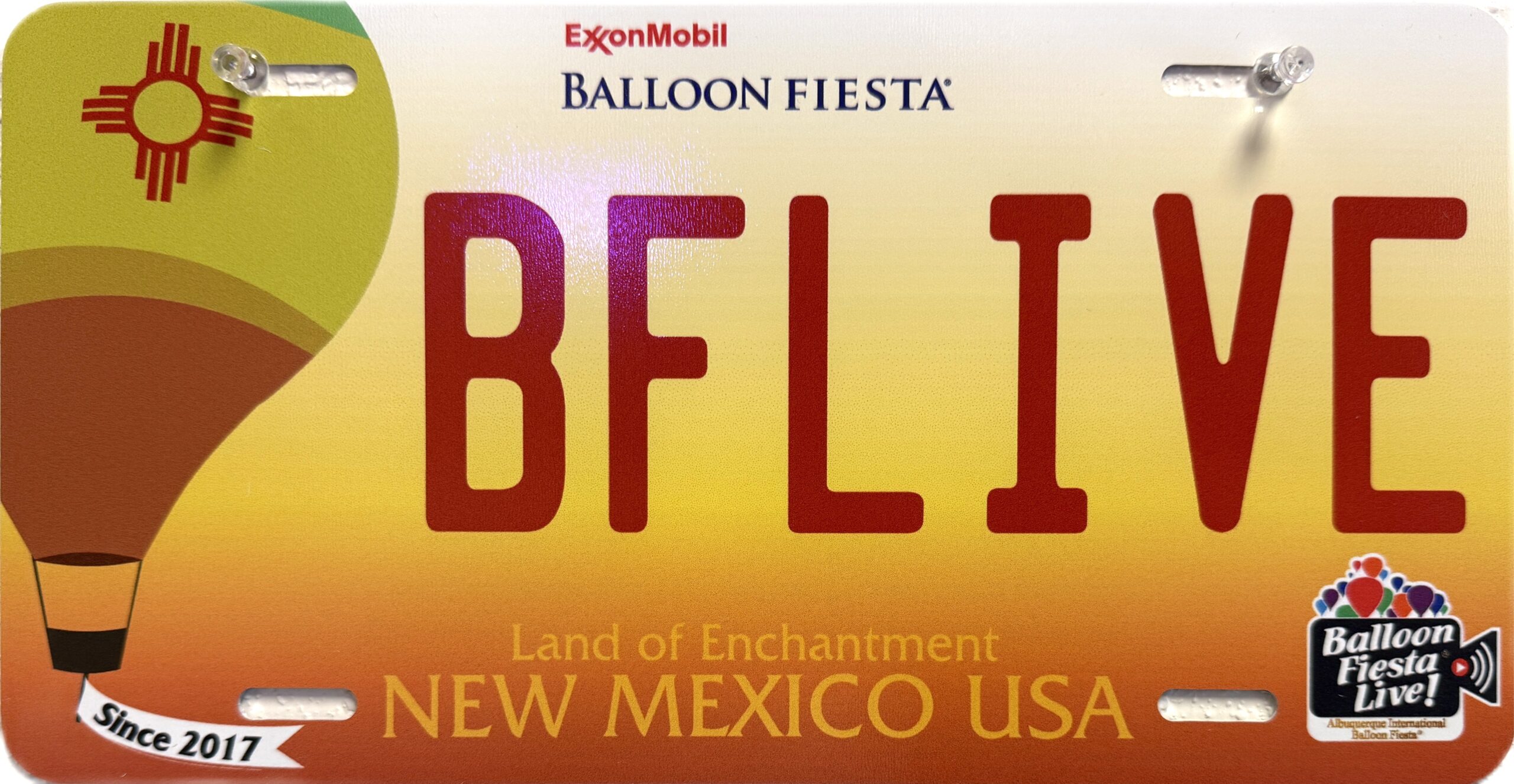 BFL License Plate 2025 Colorful license plate design featuring Albuquerque's Balloon Fiesta theme, New Mexico state symbol, and "BFLIVE" text. Includes "Land of Enchantment" and balloon graphic.