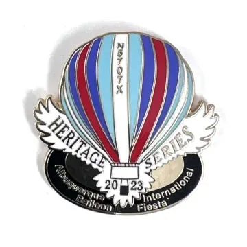 A colorful hot air balloon pin from the 2023 Albuquerque International Balloon Fiesta, featuring the "Heritage Series" label.