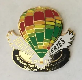 2017-Honoree-Matt-Guthrie A colorful hot air balloon pin commemorates the 2017 Albuquerque International Balloon Fiesta, featuring "Heritage Series" text and decorative wings.