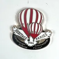 2024-Honoree-Rodney-May A pin featuring two striped hot air balloons with the text "Heritage Series 2024, Albuquerque International Balloon Fiesta."