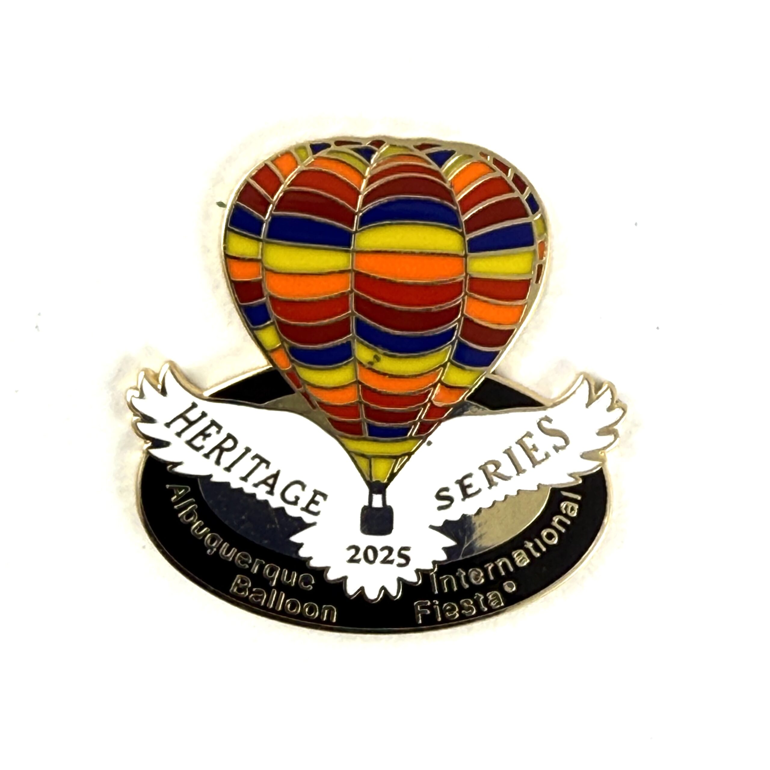 2025 Heritage Pin Colorful hot air balloon pin with "Heritage Series 2025" on wings. Text reads "Albuquerque International Balloon Fiesta." Bright design, festive theme.